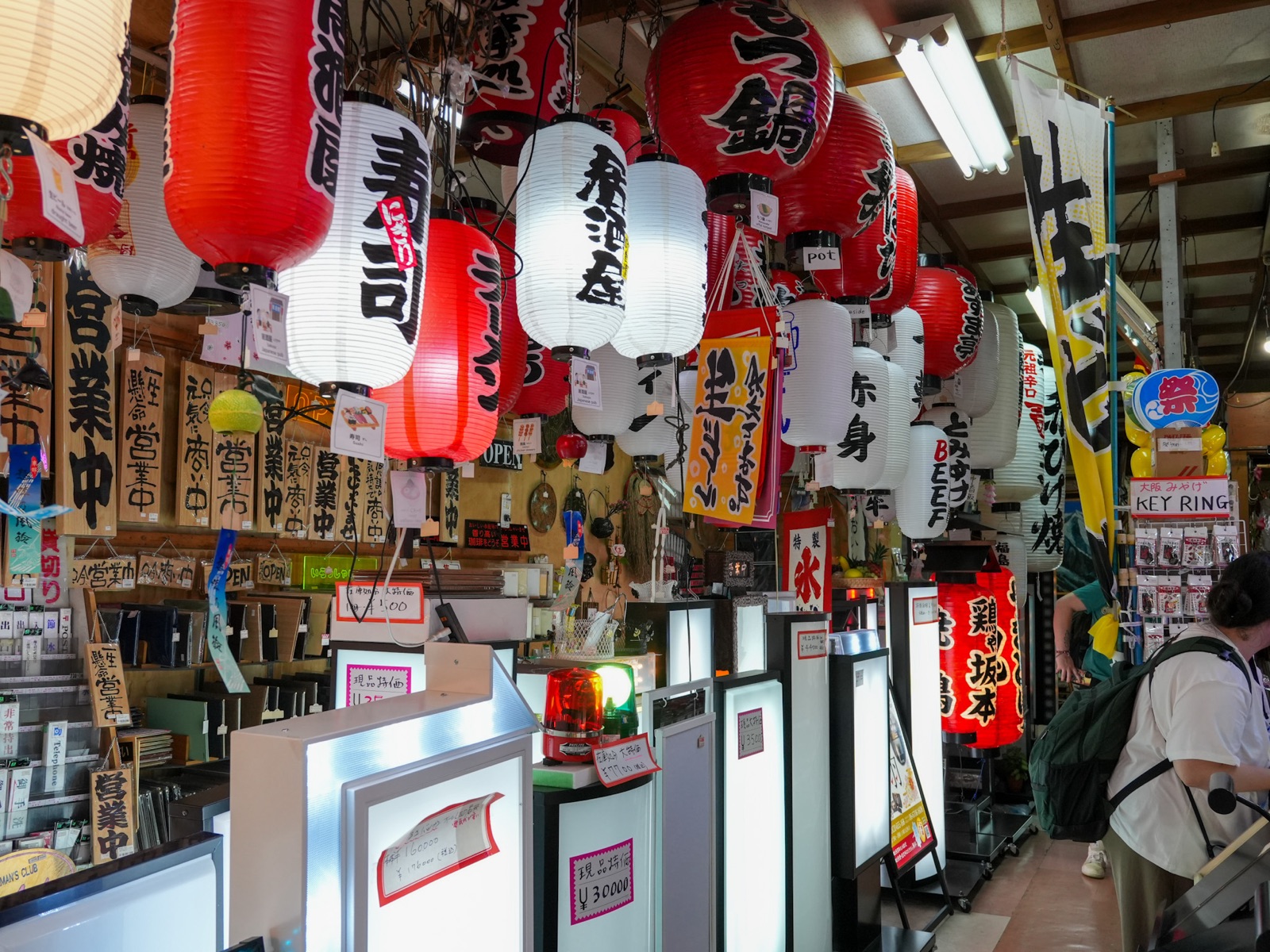 Wall of paper lanterns and handwritten menu signs in an Osaka izakaya
